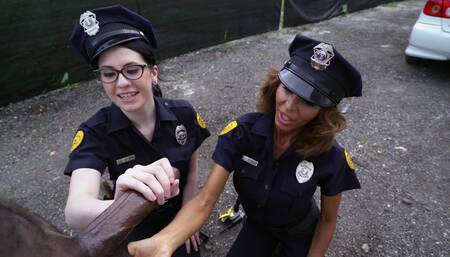 Two lady cops are having a threesome with a large black dude
