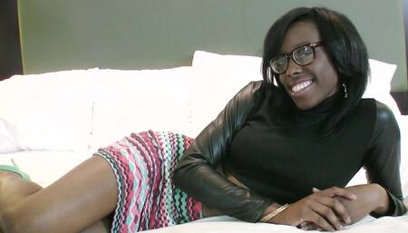 A black chick with a sexy ass and large tits is on the bed, naked