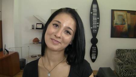 A hot brunette is making a casting video in the office