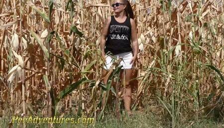 Pee in a corn field - Crossing her legs to calm her full bladder and wet her jeans in the heat outdoor