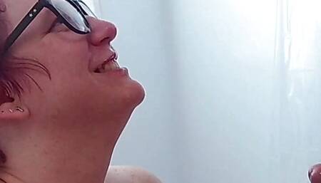 She gets a huge facial cumshot up her nose and all over her glasses while playing with his balls, with replay