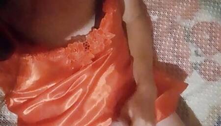 Rochelle plays with her cock in a sexy red night dress