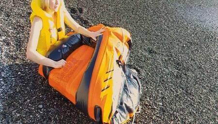 Alla deflates an orange inflatable boat on the beach!!!