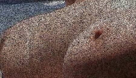 Julie Cunningham  lying nude on a beach