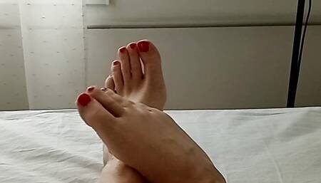 Milf tranny shows off her beautiful smooth legs and feet with red painted toes