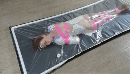 The orgasms of a doctor in a polyethylene bed in a pink bondage with a vibrator