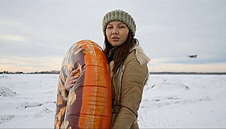 Angie pops inflatable ring on the snow Full HD