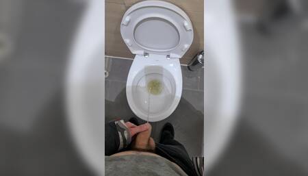 Standing peeing into the toilet on the public toilets