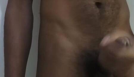 Young male masturbation on a camera behind a white background