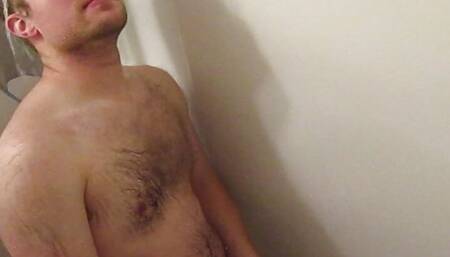Hot blonde guy plays with his cock in the shower
