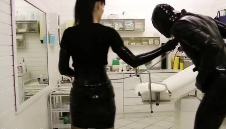 Perverted mistress is playing with tied-up gimp's cock and balls