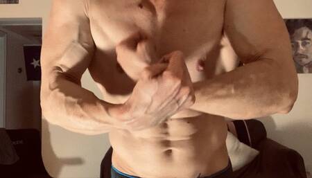 Devon flexes his shredded muscles up close