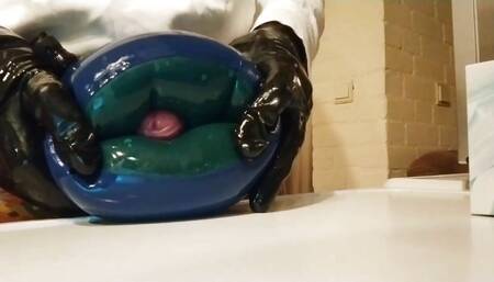 Wanking and cumming in a latex water wing