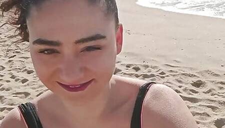 Brunette girl masturbates on public beach