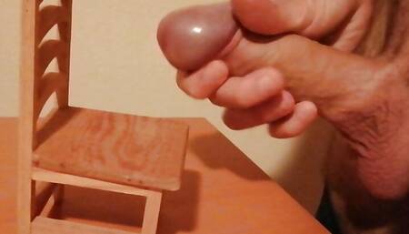 Handjob and cumshot on a small wooden chair