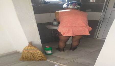 Mature woman in hijab cleans house in sexy dress