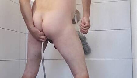 he rinses his bum with the shower hose
