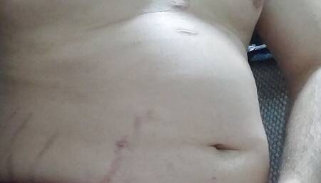 Chubby guy plays with his belly and dick