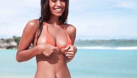 Putri Cinta stripping on a beautiful tropical beach