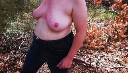 Walking naked through forest while slapping her tits
