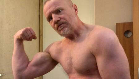 Muscular Daddy bodybuilder flexing muscles in gym vest then strips naked and jerks off his big cock!