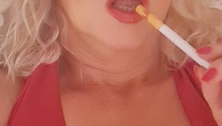 Smoker MILF Joan smokes slowly close up Marlboro red 100 with Glasses, shiny glossy red lips, deep inhalations and long exhales