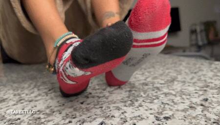 “STINKY SOCKS ON GHE KITCHEN COUNTERTOP”