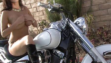 Gorgeous brunette babe fucks her juicy cunt with her favorite sex toy on a motorbike