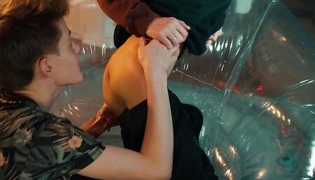 Two sweet guys share an inflatable chair