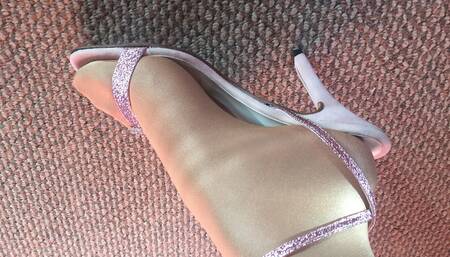 My feet close up looking in shiny glossy pantyhose and sexy pink heels sandals.