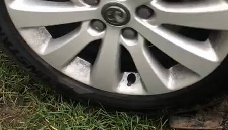 Red sole boots run over by my car in mud