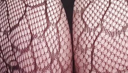 Transvestite in black nylon fishnet stockings gets a dildo in her ass