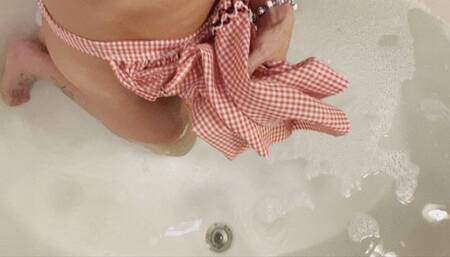 Carissa in the vintage apron and bra in the bath with bare feet