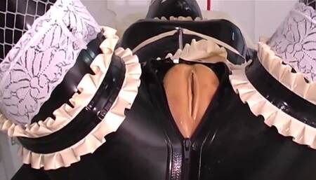 One girl is bound in latex as the other one strap-on fucks her