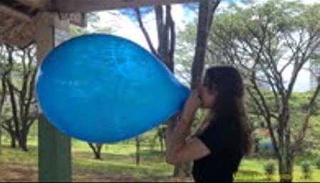 Katie Blows to Pop a Printed Unique 16" Balloon