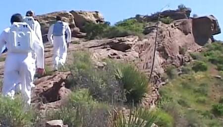 Astronaut stud lands on a planet where a blonde primitive babe sucks his cock outdoors