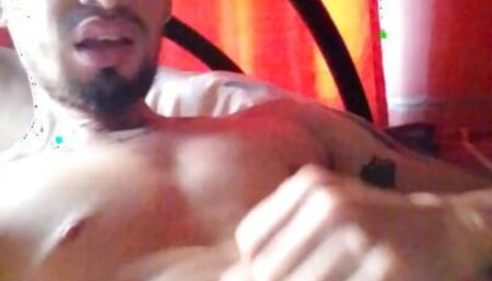 Latino squirts his chest with milk