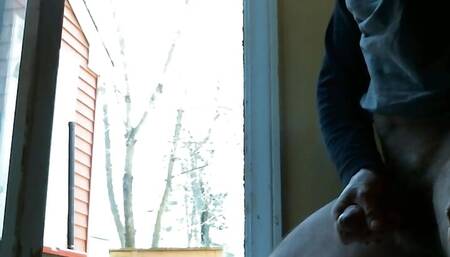 Stroking cock with cool breeze from open door