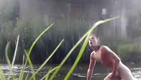 Wild teen taking bath in a river