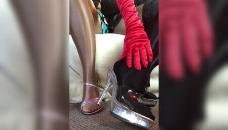 Sensual teasing close up legs and feet in Shiny glossy pantyhose and high heels.