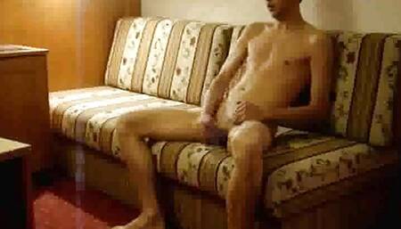 Naked twink strokes his cock in a hotel room