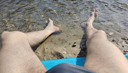 Sunbathing on the river bench, dipping my feet in the water