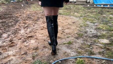 a beautiful thin girl in expensive high leather high heeled boots walks through the mud, in the end her new high heeled boots turn into a pile of mud