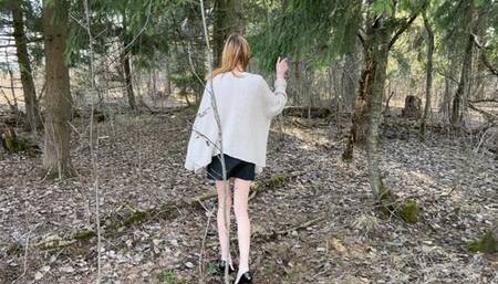 a thin long-legged girl got lost in the forest in a miniskirt and black patent leather shoes with high heels, she overcomes obstacles and loses her shoes