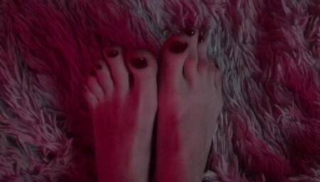 pretty long feet with red painted toenails
