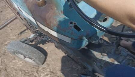 The Pedal Pumping Queen driving a vintage Tractor