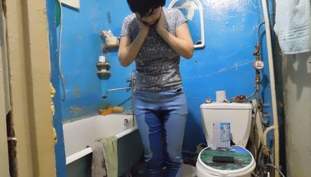 Erika is talking on the phone and pissing in her jeans