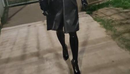 Tania walks in the street in latex