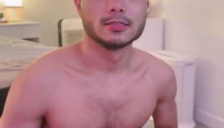 Asian boy stroking cock