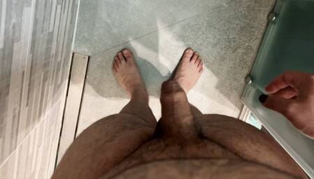 Chubby guy pees in the shower while stroking his dick
